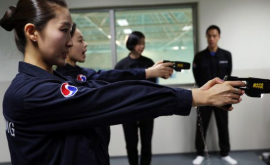 Stewardesele unei companii aeriene învăță să folosească pistolul cu electroșocuri