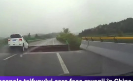Momentul în care o mașină cade întro groapă adâncă care sa format pe un drum din China în urma inundațiilor